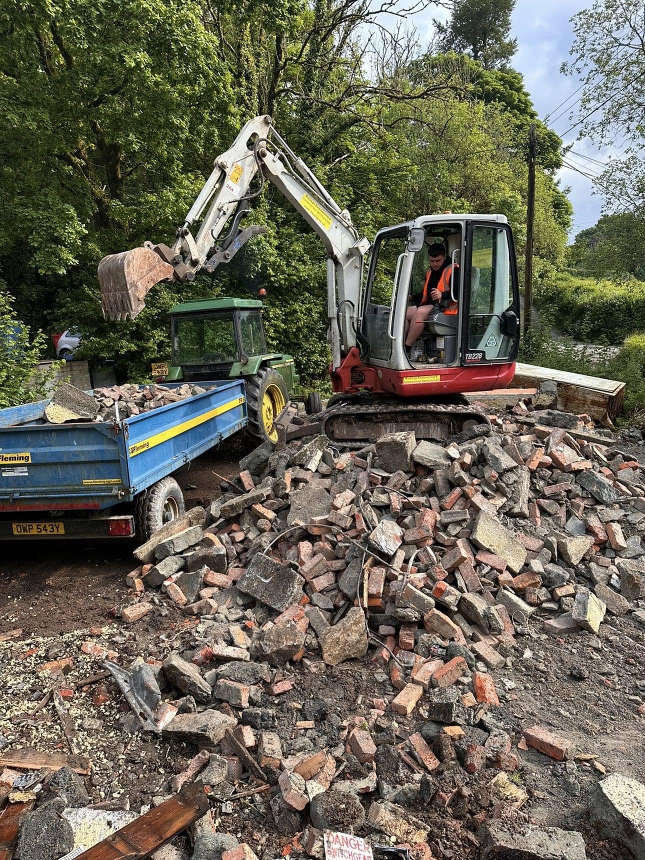 Small digger lifting bricks